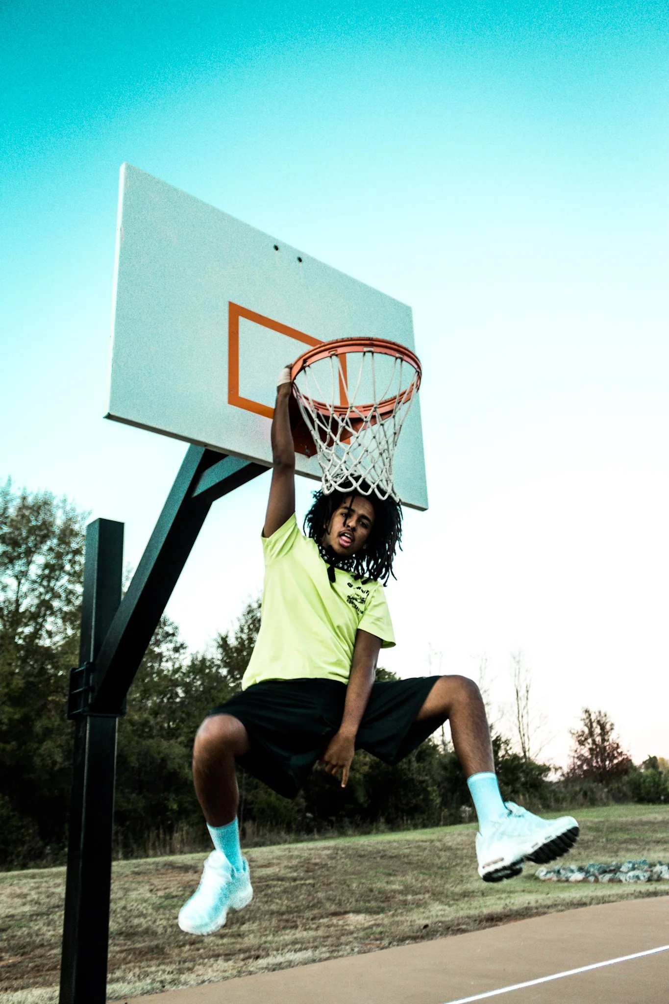 Creative basketball portrait beneath an outdoor hoop