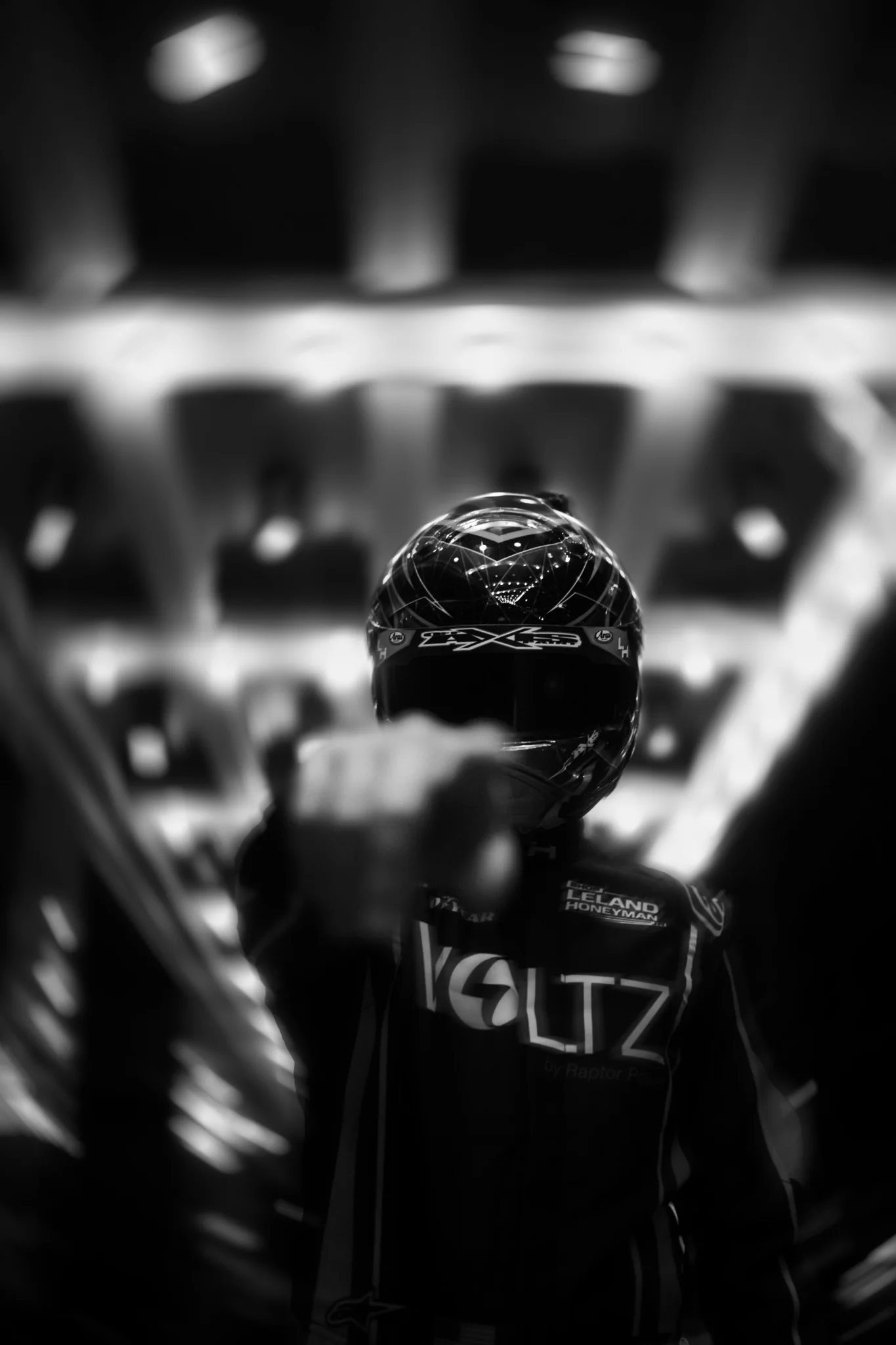 Black and white portrait of a helmeted NASCAR driver